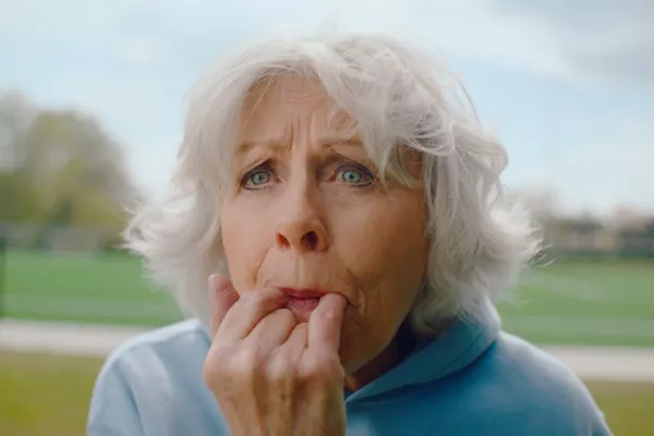 Een oudere dame is aan het fluiten.