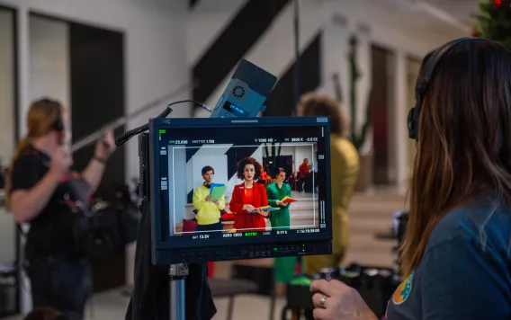 De regisseur is aan het kijken op de monitor.